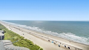 A beach with a clear sky, a sandy shore, and a few people. - Beachfront Condo, AshWorth, Free Wifi, Pools, Hot Tub | AshWorth - 1806 (North Myrtle Beach)