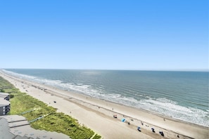A beach with a clear sky, a sandy shore, and a few people. - Beachfront Condo, AshWorth, Free Wifi, Pools, Hot Tub | AshWorth - 1806 (North Myrtle Beach)