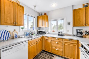 Kitchen features a large island with a sink, ample counter space, and appliances.
