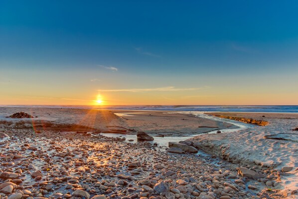Enjoy a serene beach experience with a natural pathway leading to the ocean.