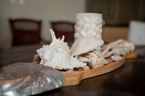 A wooden tray with various seashells and a decorative item on a table. - 9th Flr Luxury 4BR Condo- Panoramic Waterfront Views - Rooftop Pool & Lazy River (Orange Beach)