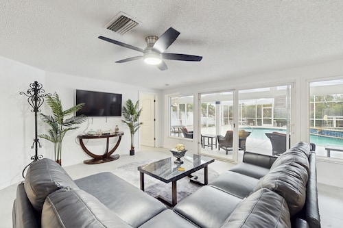 Waterfront dog-friendly home with heated private pool, dock, views, and lanai
