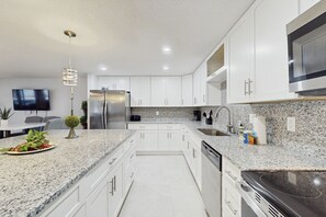 Fridge, microwave, oven, stovetop - Waterfront dog-friendly home with heated private pool, dock, views, and lanai (Anna Maria)