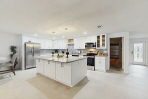 Fridge, microwave, oven, stovetop - Waterfront dog-friendly home with heated private pool, dock, views, and lanai (Anna Maria)