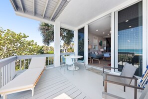 Outdoor dining - Beachfront condo with WiFi, two decks, Gulf views & pool - walk to the trolley (Holmes Beach)