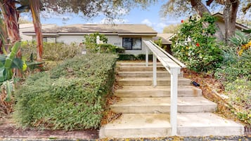 Traditional home with a pitched roof, surrounded by lush greenery and a well-maintained garden.