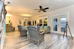 Relax in this stylish living area with a high ceiling, ocean views, and a comfortable sofa.