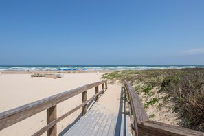 Walk along the boardwalk to the sandy beach.