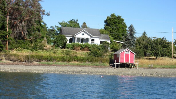 A house with a dock and a small shed by the water. - Water front property with spectacular views.  (Marrowstone)