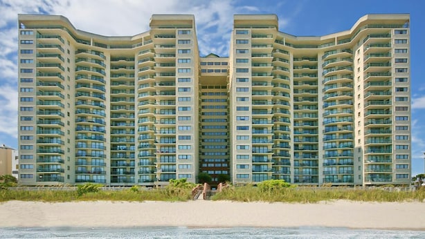 A high-rise hotel with multiple balconies, located near a beach. - 9th Floor Oceanfront Condo, Jacuzzi Tub, Outdoor Pool | Ocean Bay Club - 906 (North Myrtle Beach)