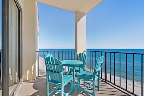 Enjoy the ocean view from this balcony with a round table and four chairs.