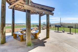 Enjoy outdoor dining and social gatherings on the patio with unobstructed ocean views.