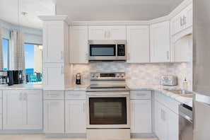 Prepare meals in the spacious kitchen with a large window offering a view of the surrounding area.