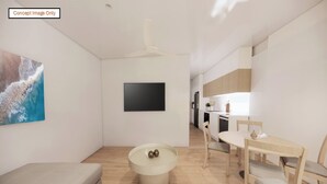 A modern interior with a sofa, a round table with decorative balls, a dining area with chairs, and a kitchen in the background. - Discovery Parks - Townsville (Wulguru)