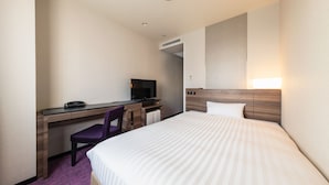 A hotel room with a bed, a desk with a chair, a television, and a headboard with a light. - JR East Hotel Mets Mito (Mito)