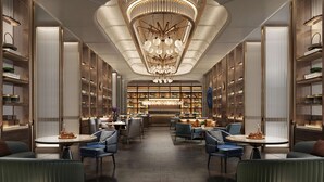 A modern interior with a central bar area, seating arrangements, and bookshelves. - WYNDHAM WENZHOU (Wenzhou)