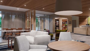 A modern interior with a seating area, a round wooden table, and a large pendant light.
