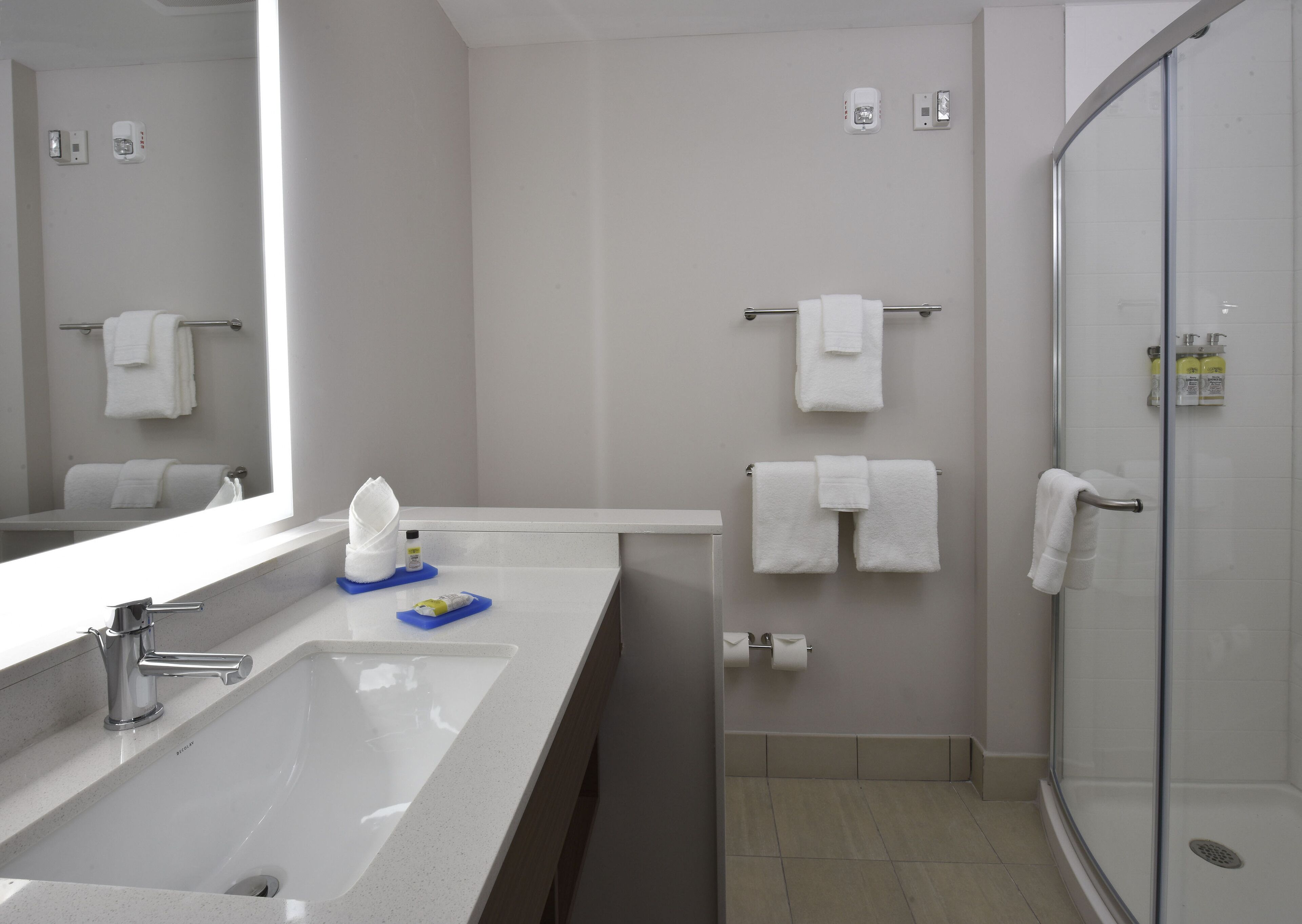 designer toiletries, hair dryer, towels, soap