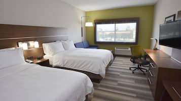 A hotel room with two beds, a desk, a chair, a TV, and a window with a view.