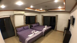A hotel room with two beds, a ceiling fan, an air conditioning unit, a television, and a sliding door. - Baan TonPalm Pool Villa Huahin (Hua Hin)