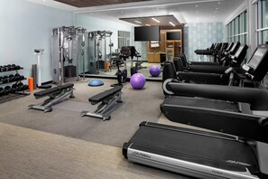 A modern gym with cardio equipment, weight machines, and free weights. - Hotel Indigo Gainesville-Celebration Pointe by IHG (Gainesville)