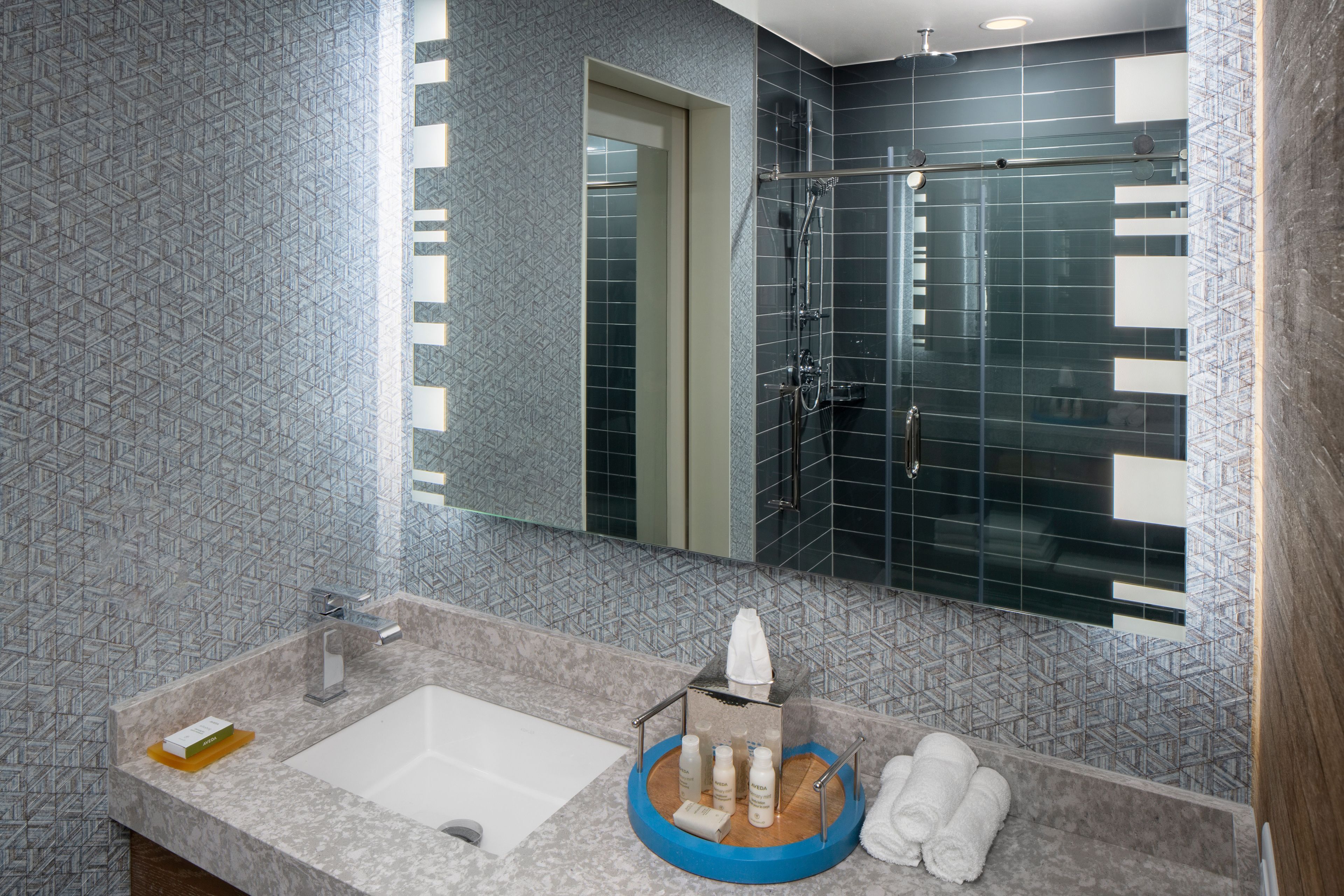 designer toiletries, hair dryer, towels, soap