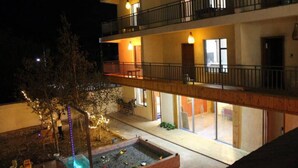 A multi-story building with balconies, a swimming pool, and outdoor lighting. - Shangri-La Youyou Inn (Deqin)