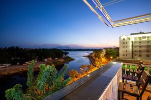 A high-rise hotel with a view of a river and distant mountains. - The Art - Big Sea Villa Hoi An Riverside (Da Nang)