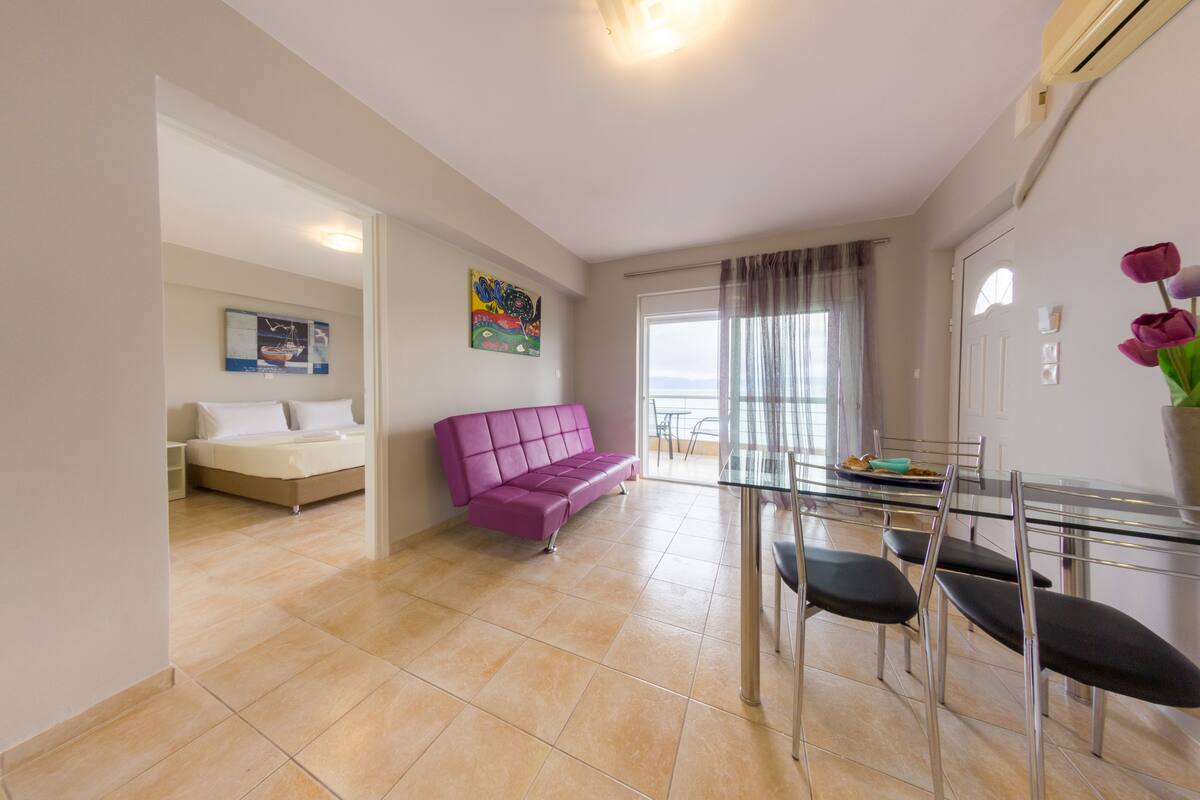 Apartment, 1 Bedroom, Balcony, Sea View (Grape Tree) | Living area | 32-inch flat-screen TV with digital channels, LED TV