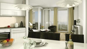 A modern kitchen with a dining area, large windows, and a view of the city.