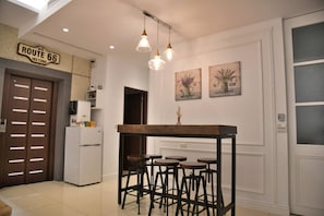 A kitchen with a bar area, a refrigerator, and a sign reading "US Route 66 Historic". - Love 300 (Luodong)