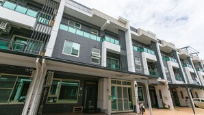 A multi-story residential building with balconies, large windows, and a brick facade. - Love 300 (Luodong)