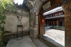 A traditional building with a wooden door and a stone wall.