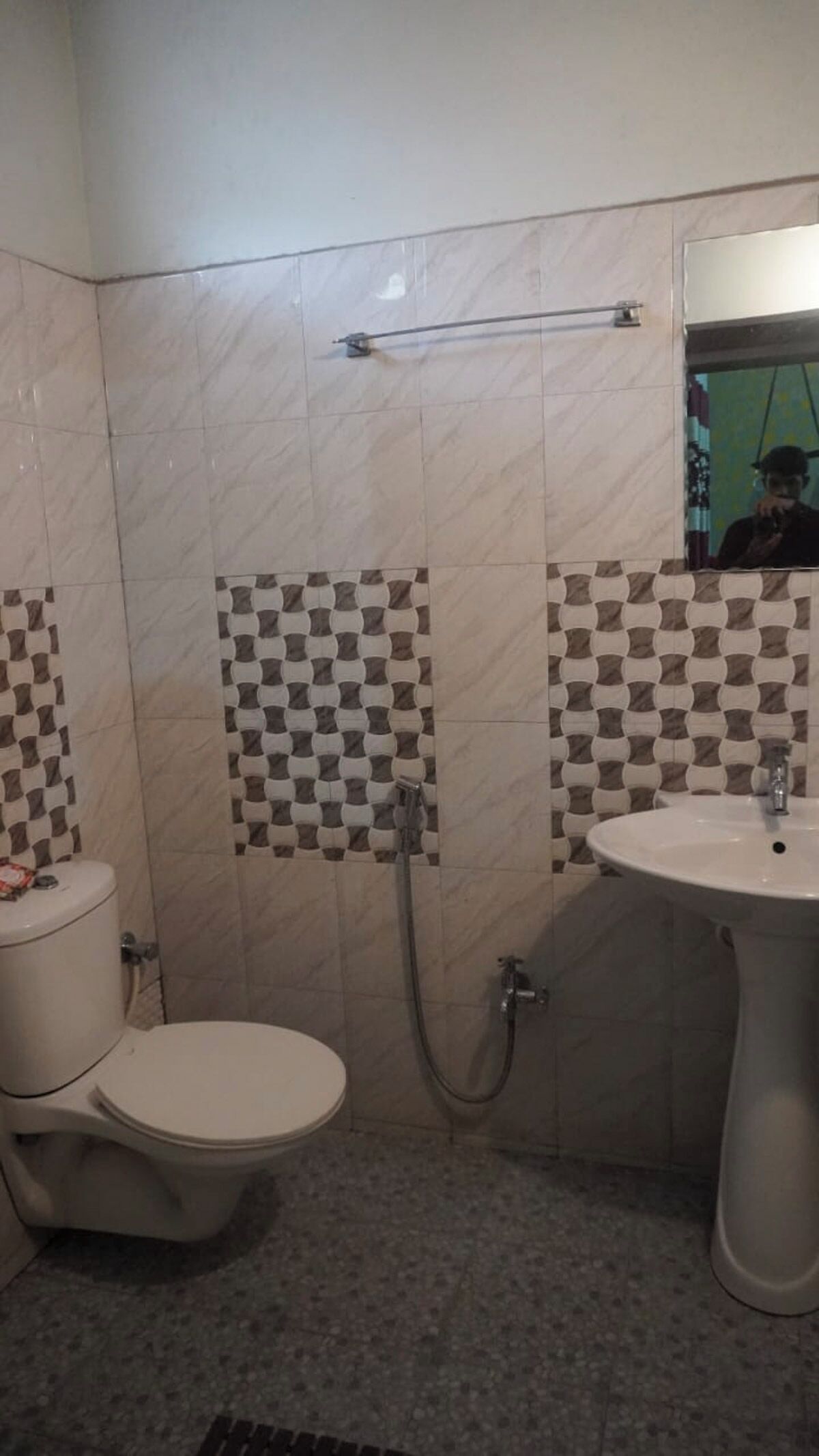 A bathroom with a toilet, sink, and shower.