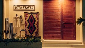 A wooden door with a sign above it that reads "JOY of TRAVEL". - Orrs (Chatan)