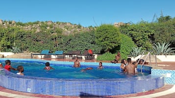 Outdoor pool, pool loungers, lifeguards on site