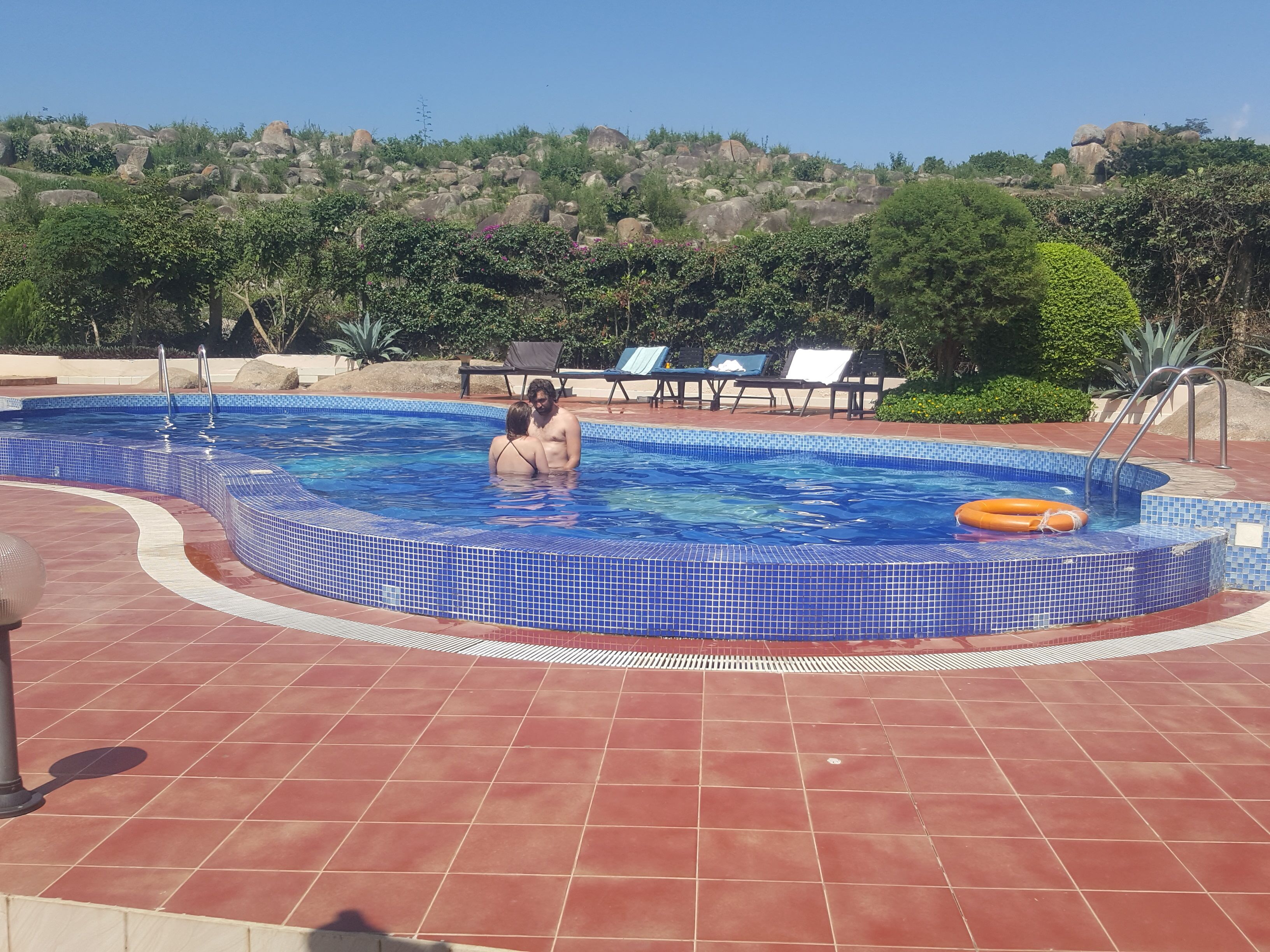 outdoor pool, pool loungers, lifeguards on site