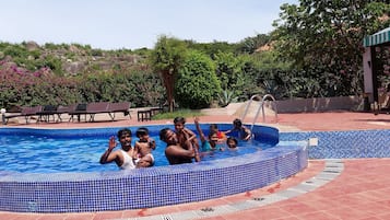 Piscina externa, espreguiçadeiras, salva-vidas no local