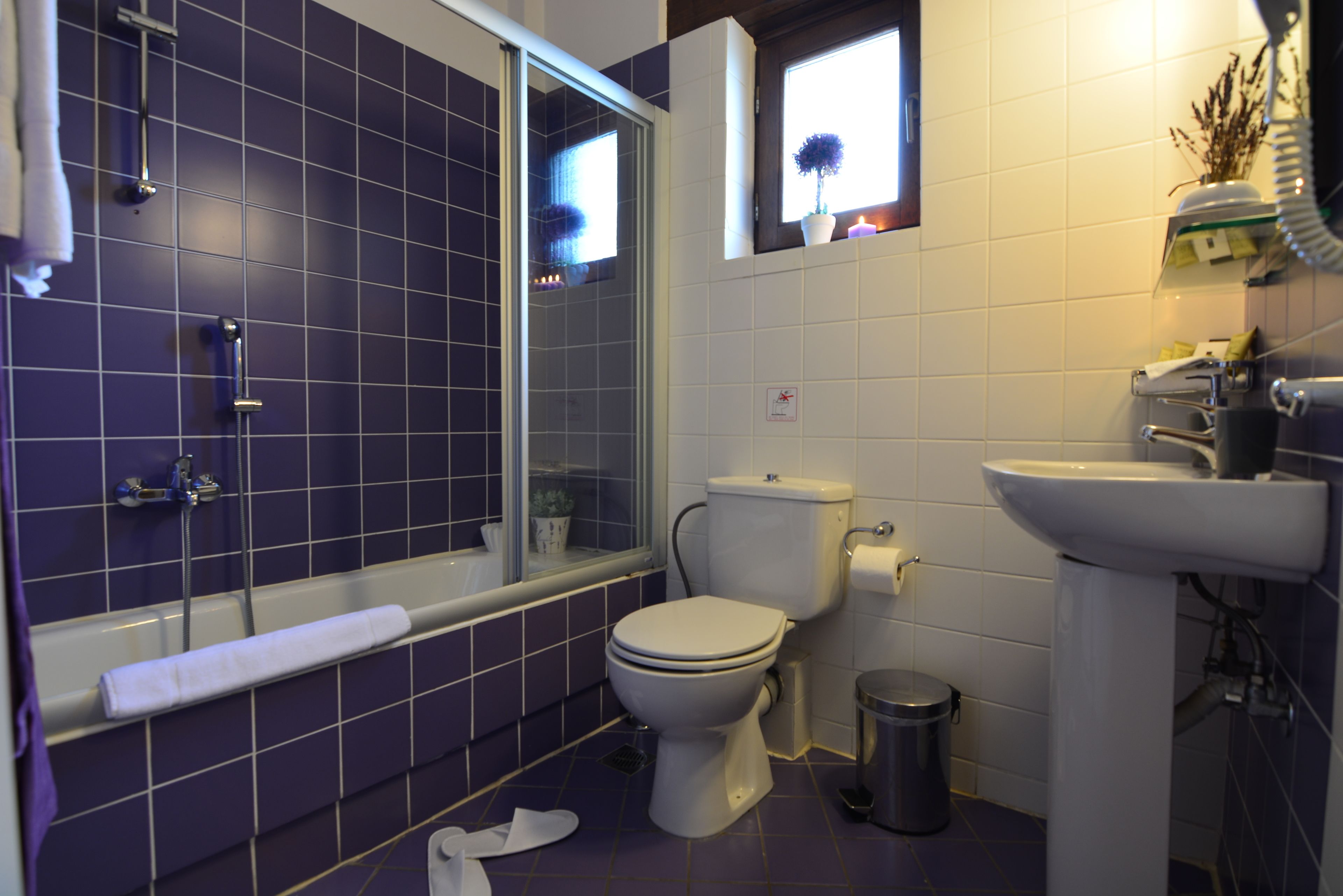 A bathroom with a bathtub, toilet, and sink.
