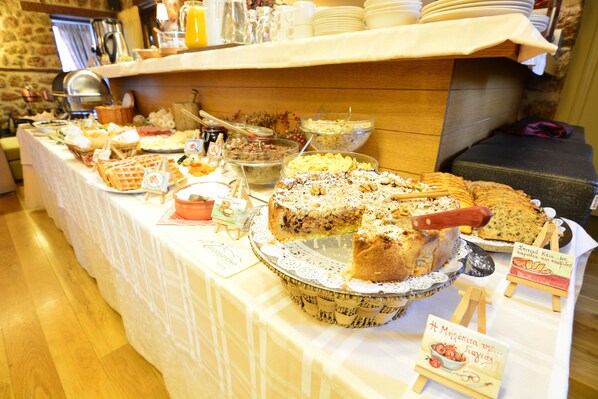 A buffet table with various food items and a cake.
