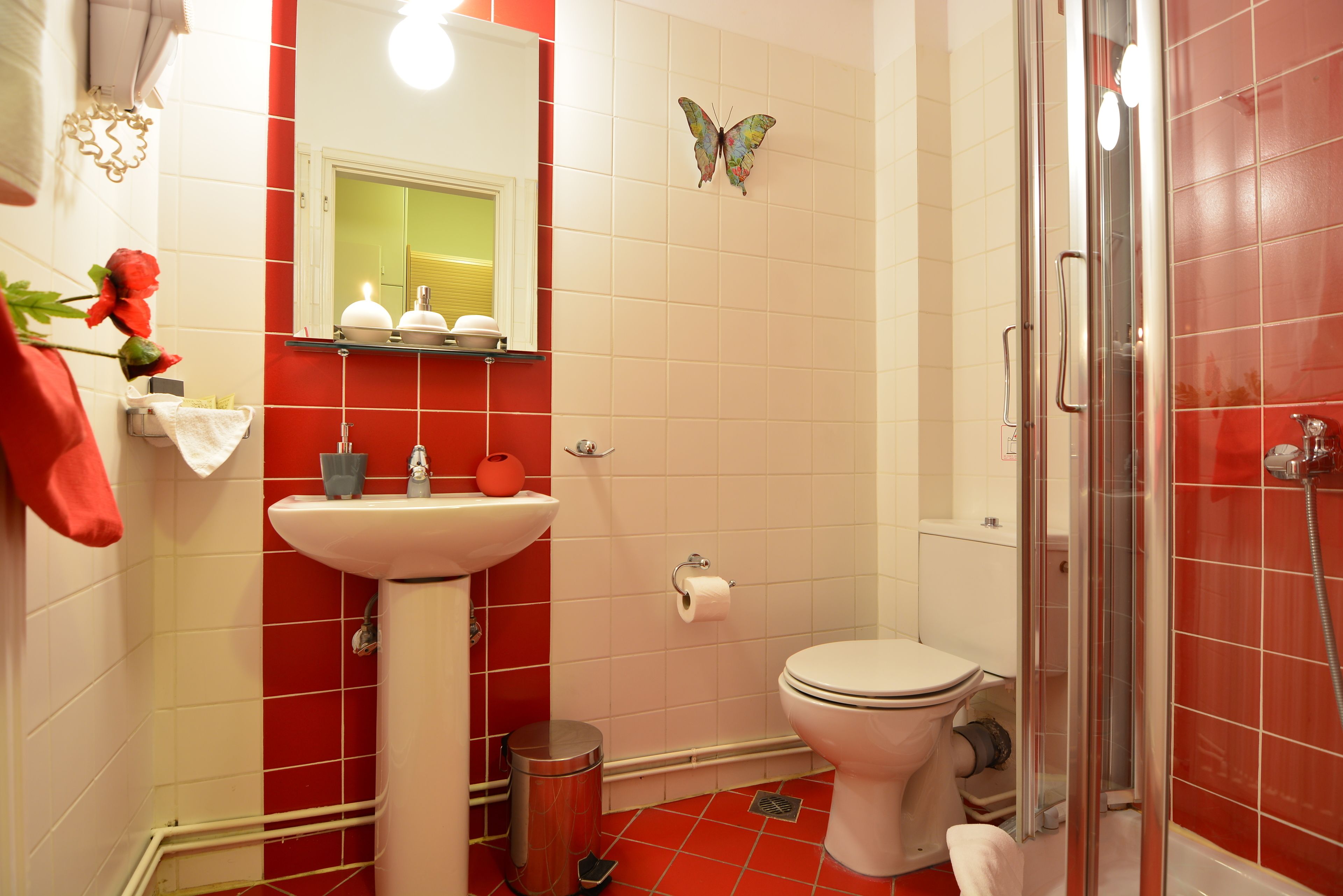 A bathroom with a toilet, sink, and shower.