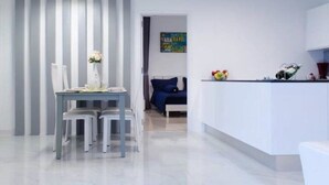 A modern, minimalist living space with a dining area, a kitchen, and a bedroom. - L.A. Pool Villa Huahin (Hua Hin)