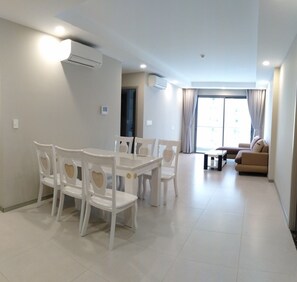 Deluxe Apartment, 3 Bedrooms, Kitchen, Poolside | Living area | 55-inch flat-screen TV with cable channels, TV, DVD player