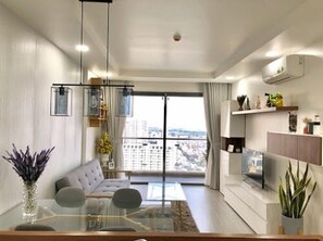 Deluxe Apartment, 2 Bedrooms, Pool Access, City View | Living room | 55-inch flat-screen TV with cable channels, TV, DVD player - The GoldView Luxury Apartment (Ho Chi Minh City)