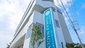 A hotel sign with the name "HOTEL TOMAS NAGO" in large letters. - Hotel Tomas Nago (Nago)