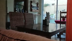 A living room with a sofa, a dining table, and a ceiling fan. - Casa Antiquary (Benitachell)
