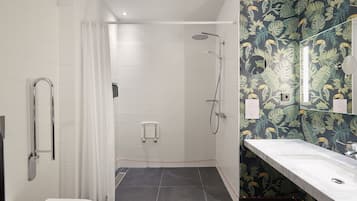 A bathroom with a shower, toilet, and sink.