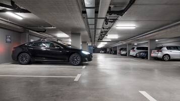 A multi-level parking garage with cars parked in designated spaces.