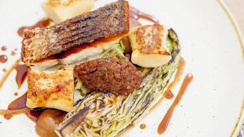 A plate of food with grilled meat, tofu, and vegetables.