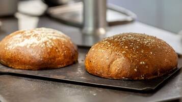 Two loaves of bread on a baking tray.
